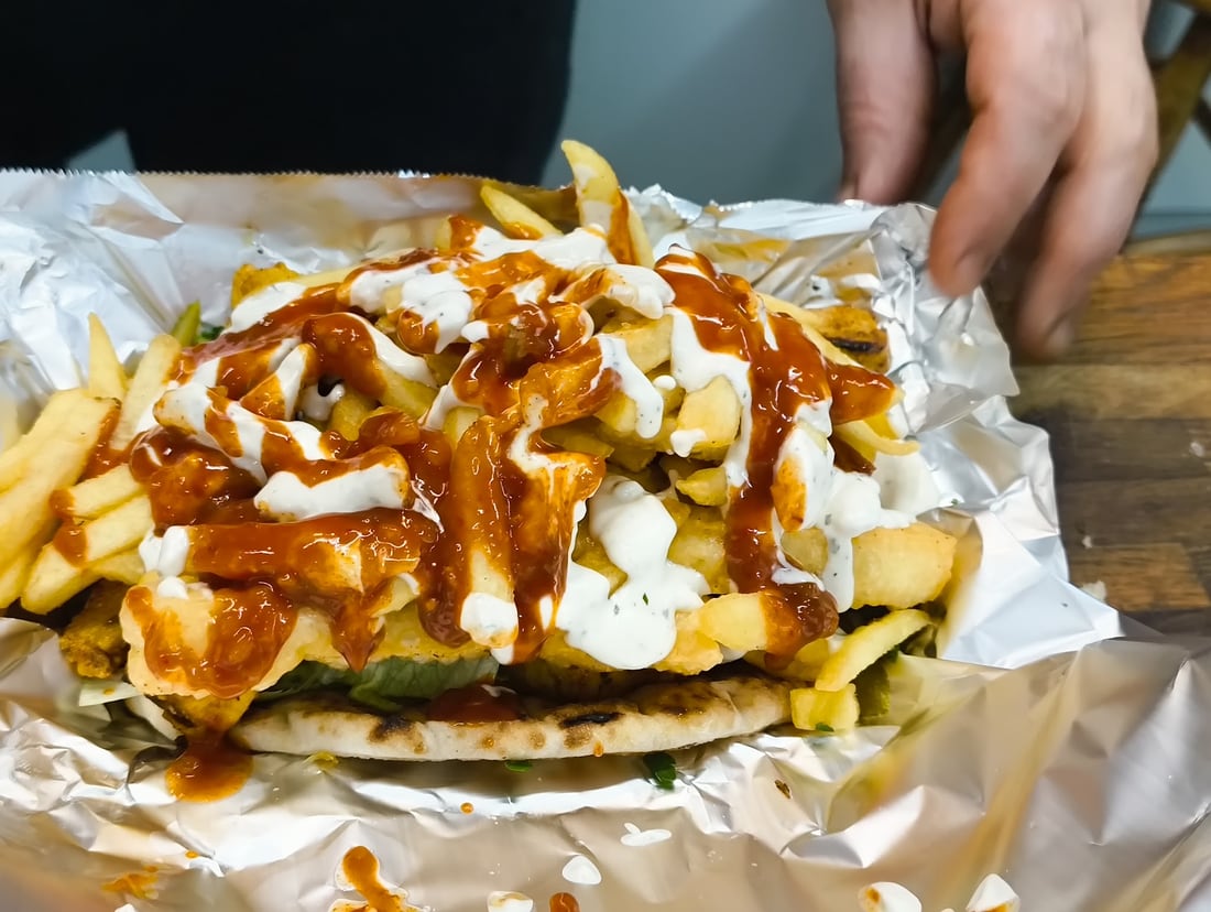 Gyro filled with chicken, chips and sauce